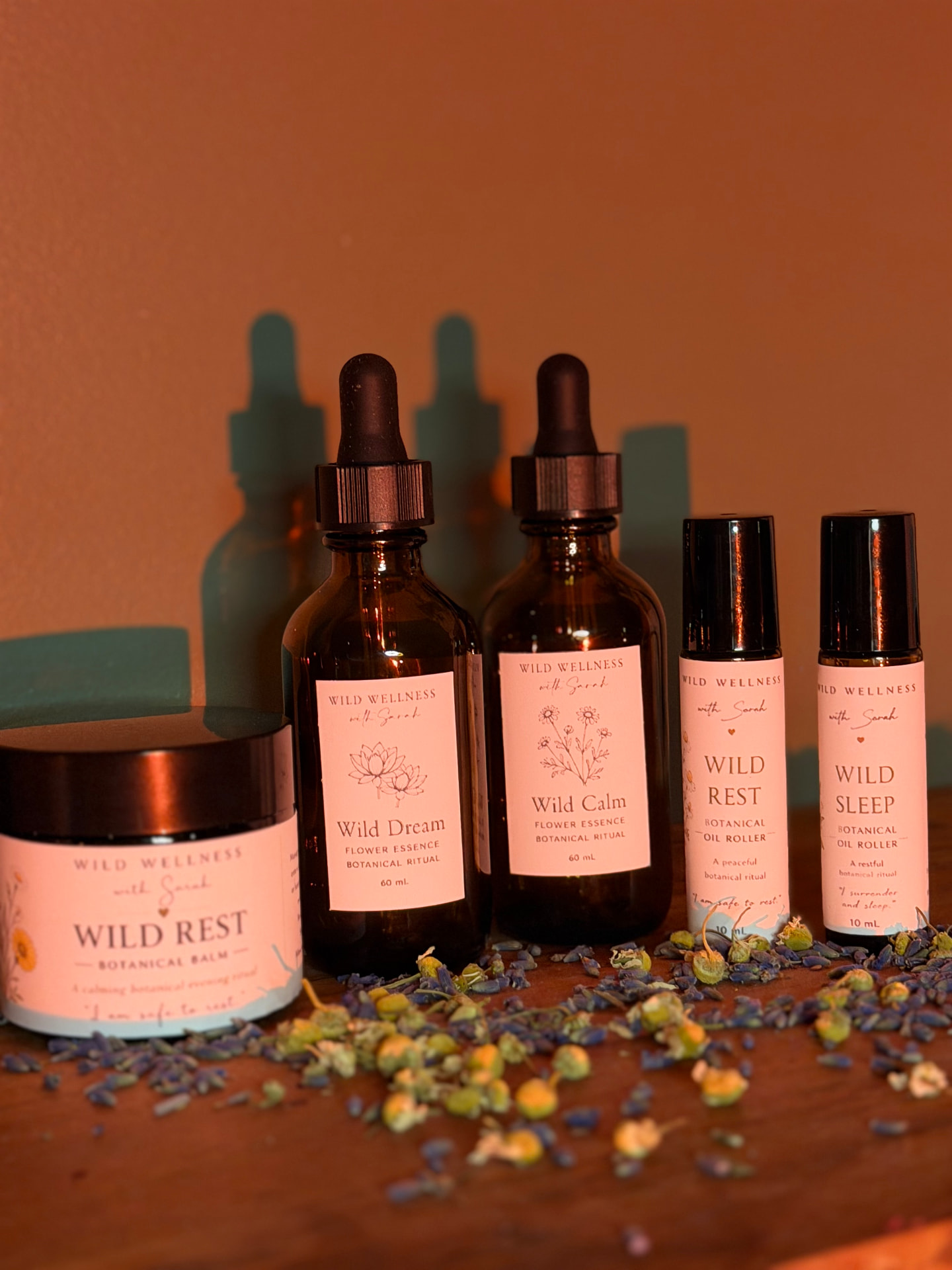 Wild Wellness botanical balm, flower essences and oil rollers with dried lavender and chamomile